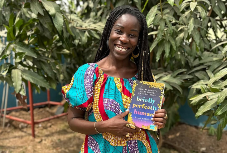 Alua Arthur holding her book